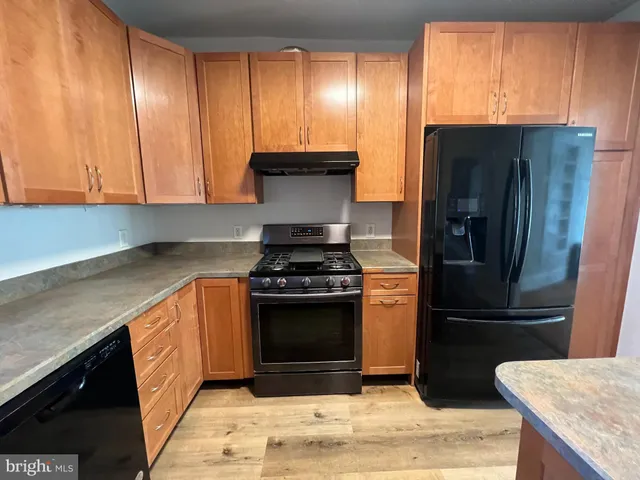 a kitchen with a refrigerator sink and stove