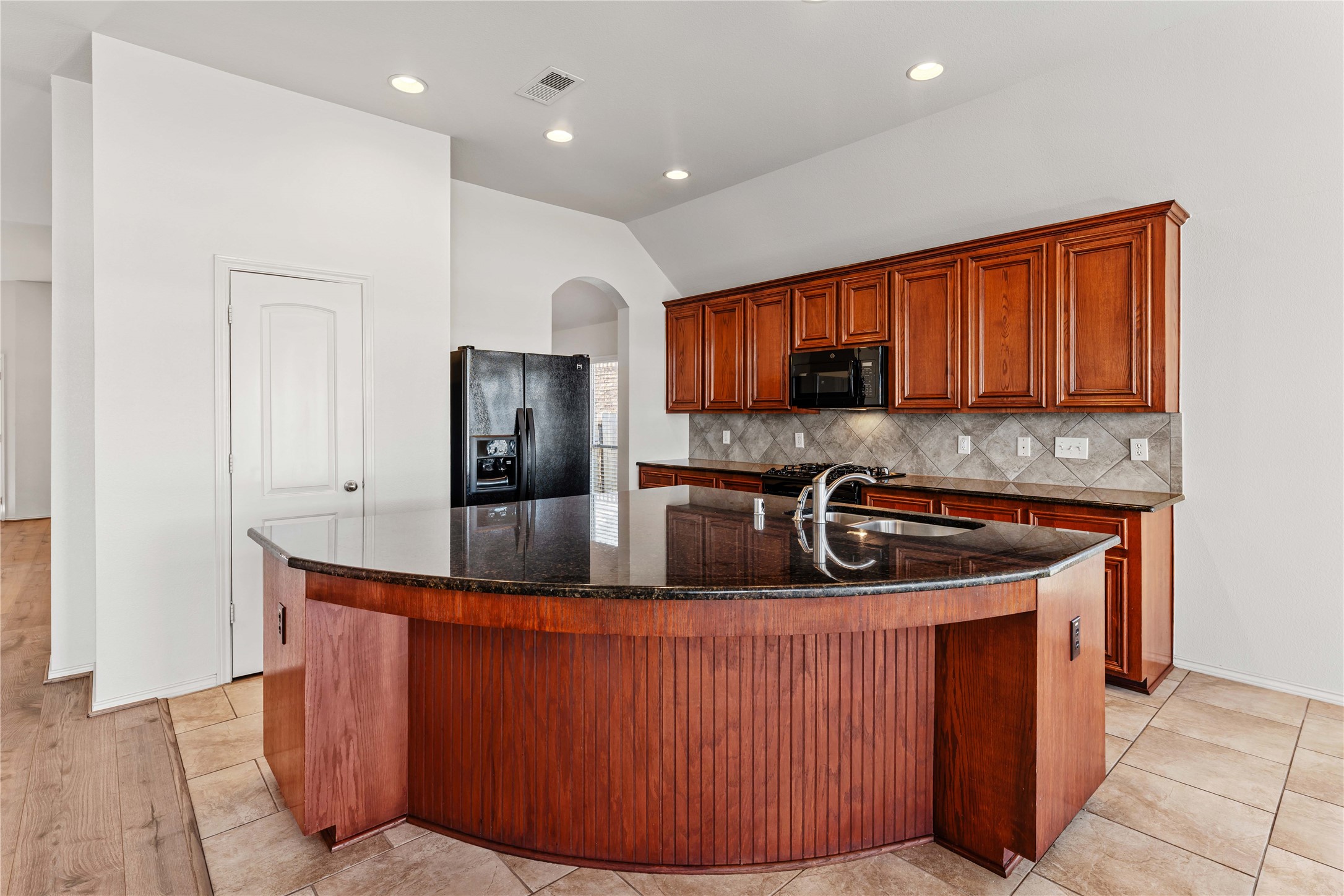 1602 Eden Meadows Drive Spring, TX 77386 - Photo 13 of 42 a kitchen with stainless steel appliances granite countertop a stove a sink and a refrigerator
