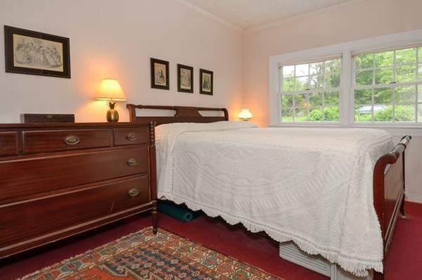 416 Linebrook Road Ipswich, MA 01938 - Photo 14 of 30 a bed room with a bed and a lamp