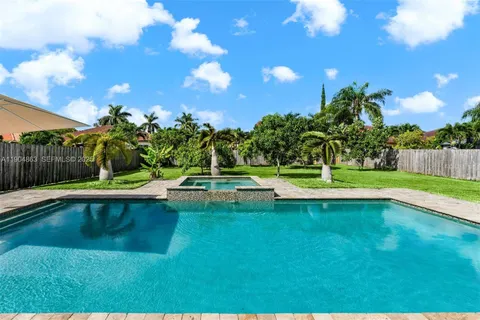 a view of a swimming pool with a yard