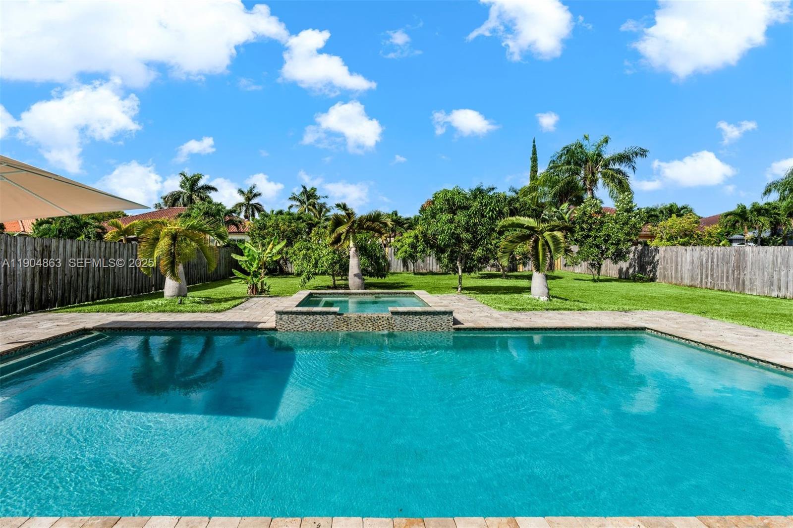 17080 Southwest 92nd Court Palmetto Bay, FL 33157 - Photo 1 of 40 a view of a swimming pool with a yard