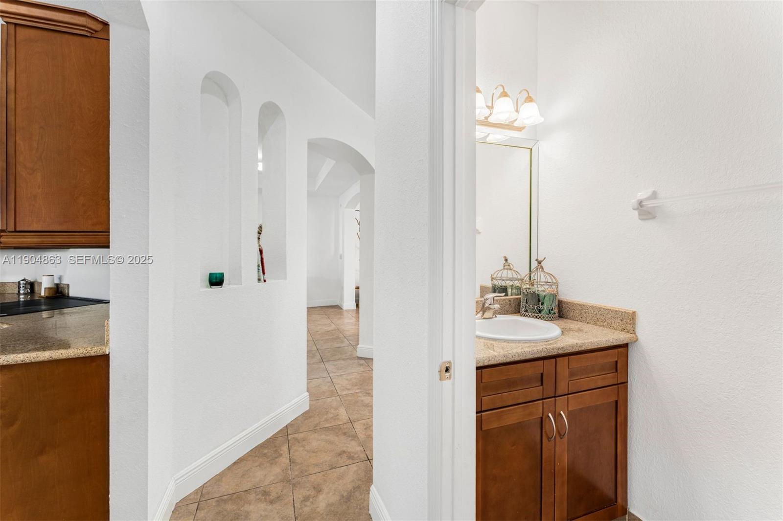 17080 Southwest 92nd Court Palmetto Bay, FL 33157 - Photo 15 of 40 a bathroom with a sink and a mirror