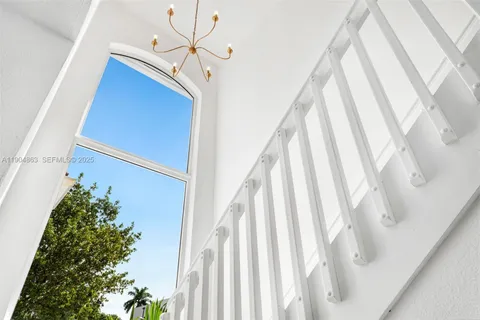 a view of staircase with rug and white walls