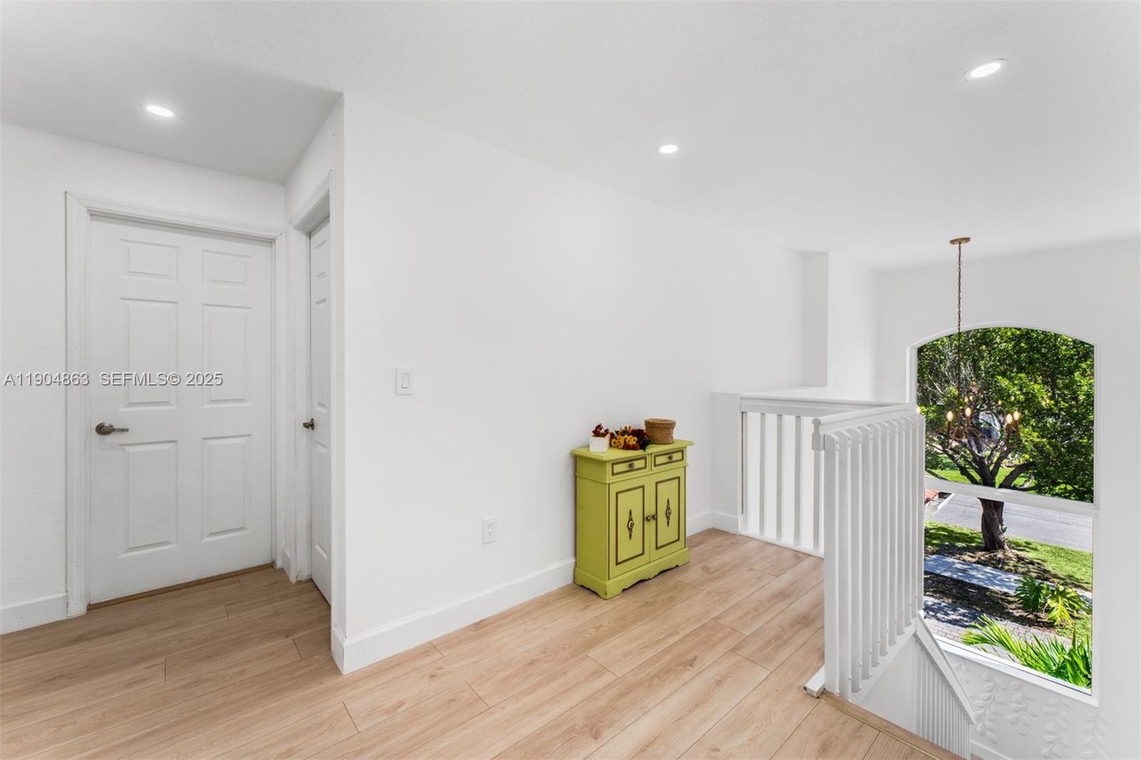 17080 Southwest 92nd Court Palmetto Bay, FL 33157 - Photo 19 of 40 an empty room with wooden floor and windows