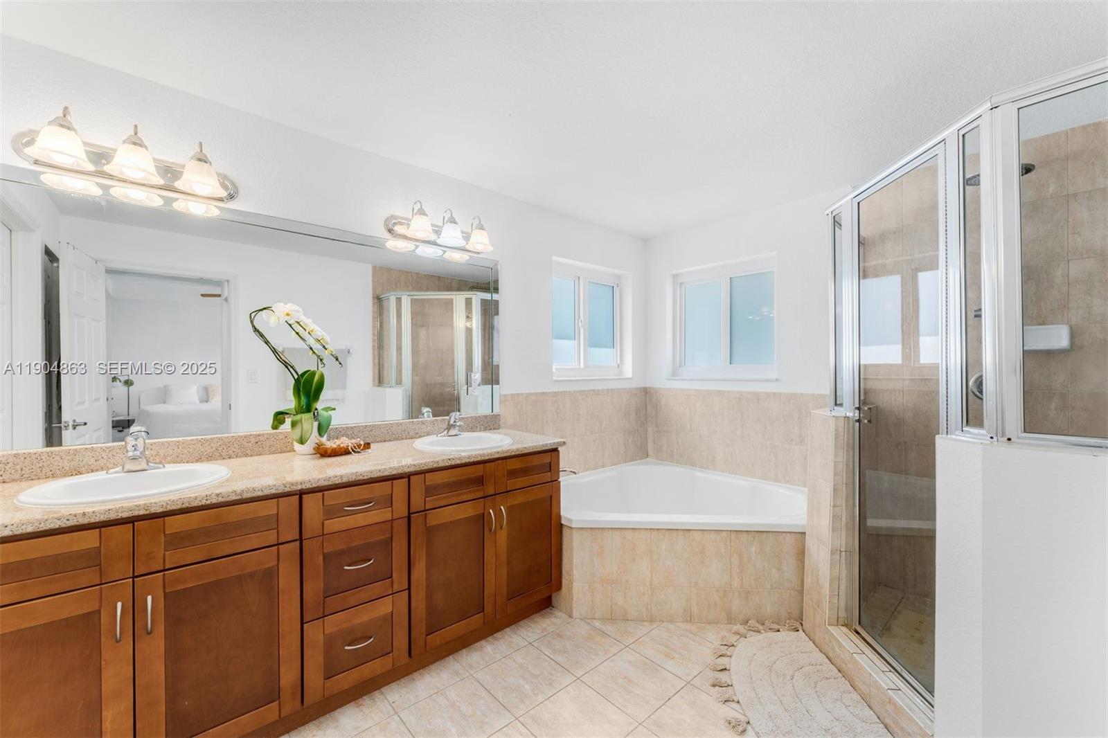 17080 Southwest 92nd Court Palmetto Bay, FL 33157 - Photo 23 of 40 a bathroom with a tub a sink and a mirror