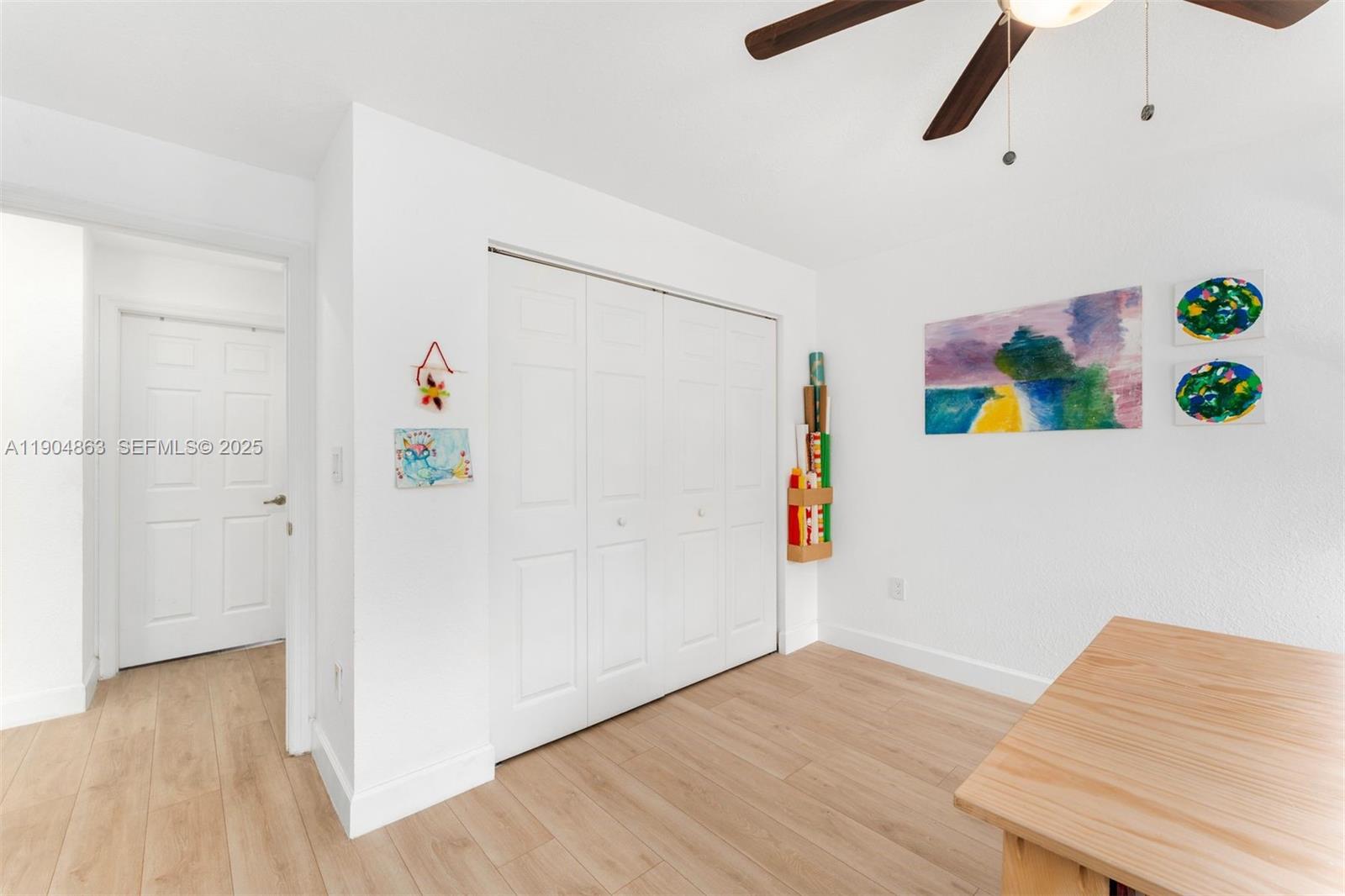 17080 Southwest 92nd Court Palmetto Bay, FL 33157 - Photo 28 of 40 a room with a refrigerator and a wooden floor