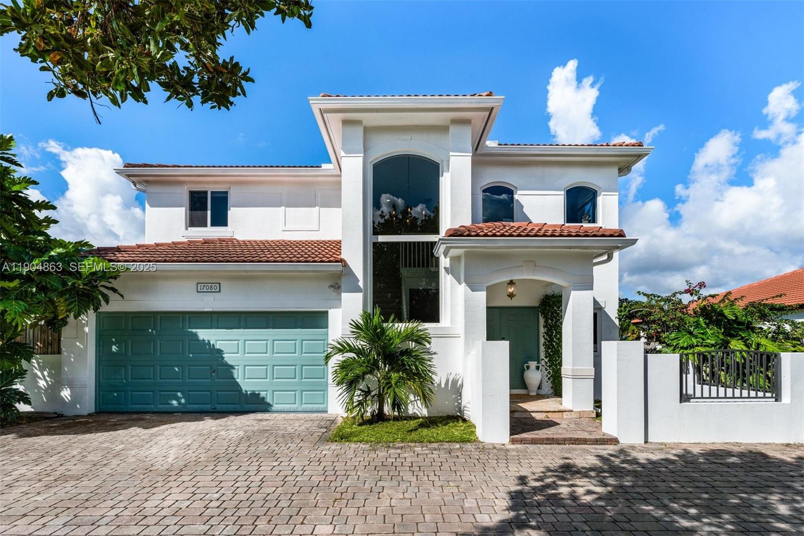 17080 Southwest 92nd Court Palmetto Bay, FL 33157 - Photo 39 of 40 a front view of a house with a garden