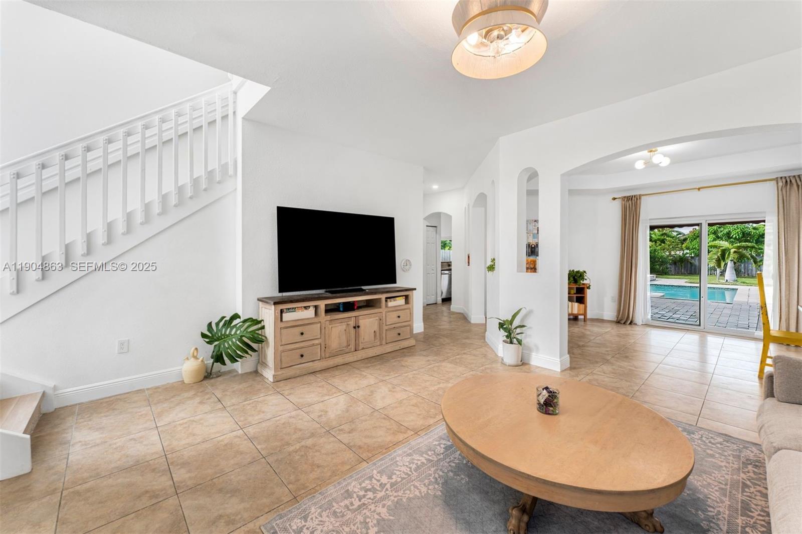 17080 Southwest 92nd Court Palmetto Bay, FL 33157 - Photo 4 of 40 a living room with furniture and a flat screen tv