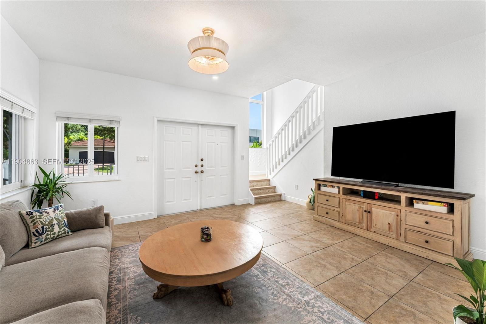 17080 Southwest 92nd Court Palmetto Bay, FL 33157 - Photo 6 of 40 a living room with furniture and a flat screen tv