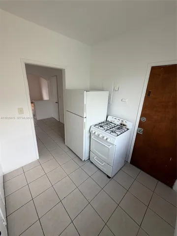 a white kitchen with a stove