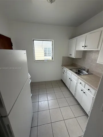 a kitchen with granite countertop cabinets and a stove top oven