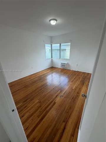 an empty room with wooden floor
