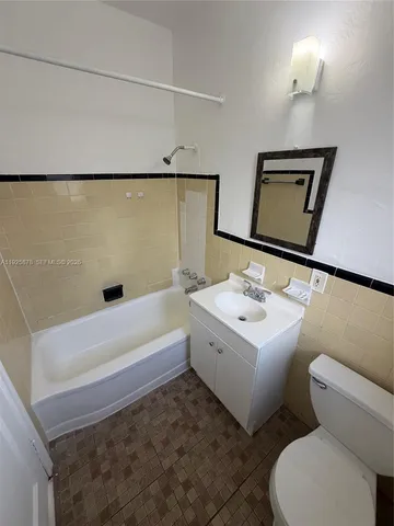 a bathroom with a sink a toilet and bathtub