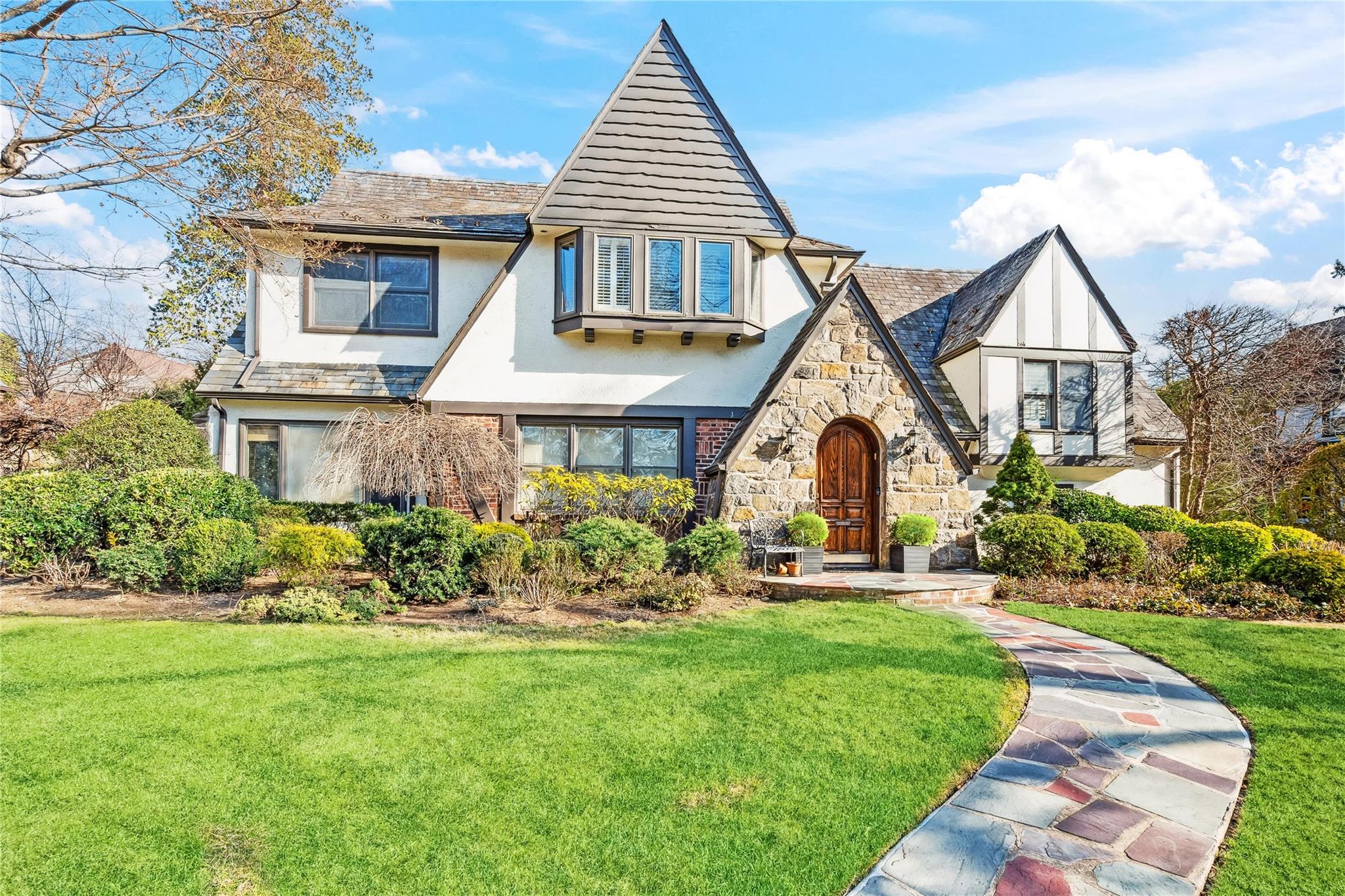 6 Darley Road Great Neck, NY 11021 - Photo 1 of 1 a front view of a house with a yard and potted plants
