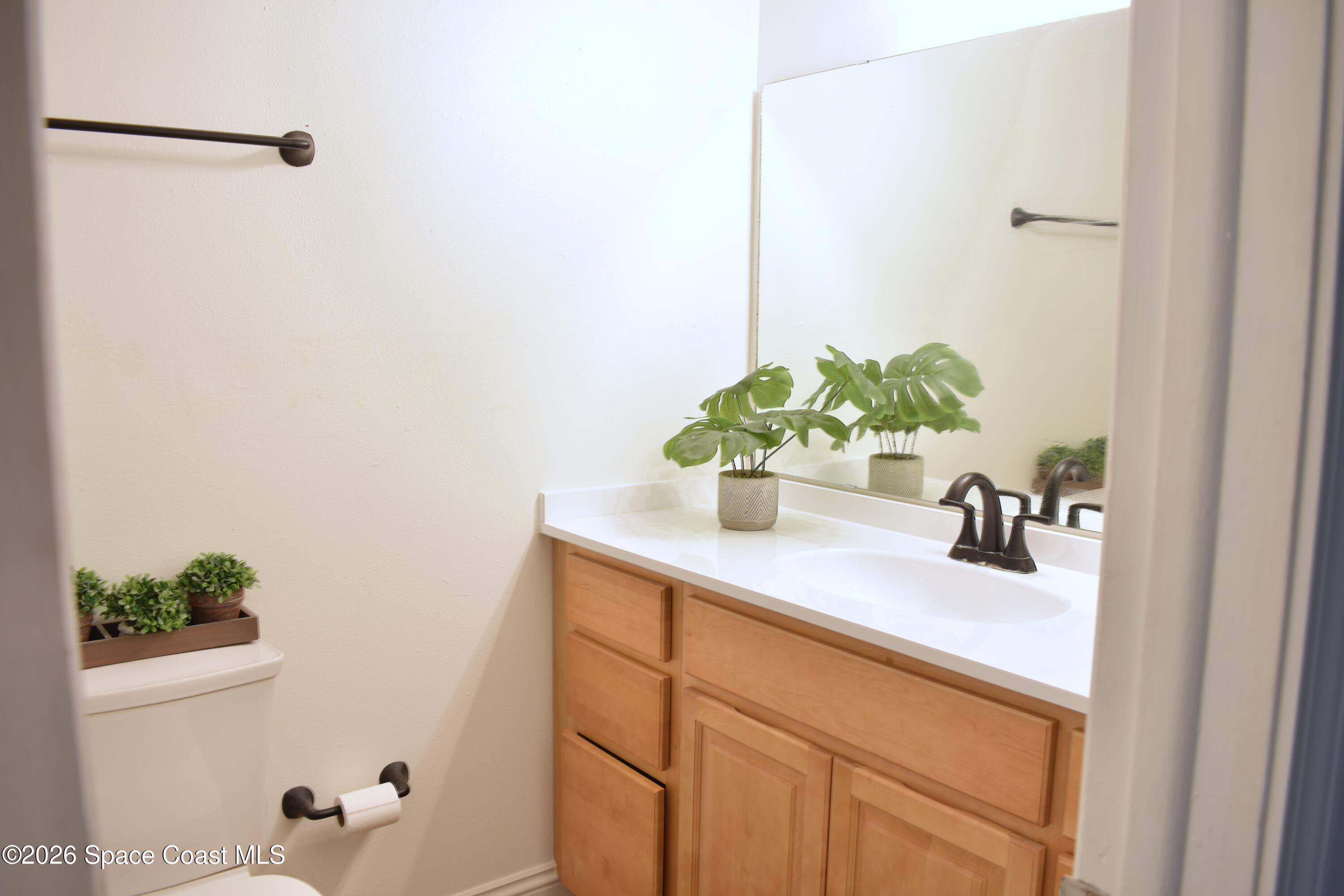 1413 Floyd Drive Rockledge, FL 32955 - Photo 15 of 17 a bathroom with a sink a mirror and vanity