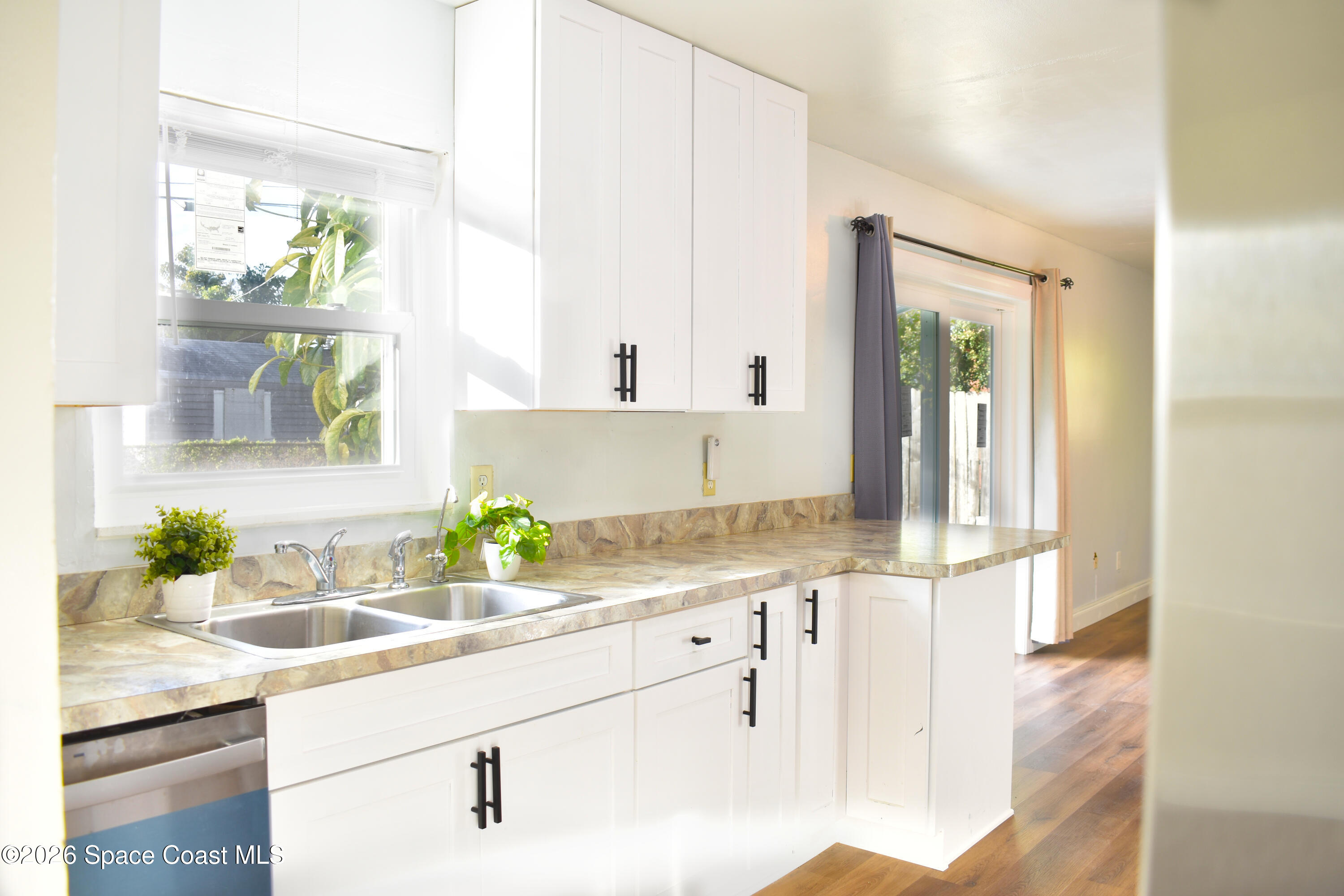 1413 Floyd Drive Rockledge, FL 32955 - Photo 4 of 17 a kitchen with a sink and a window