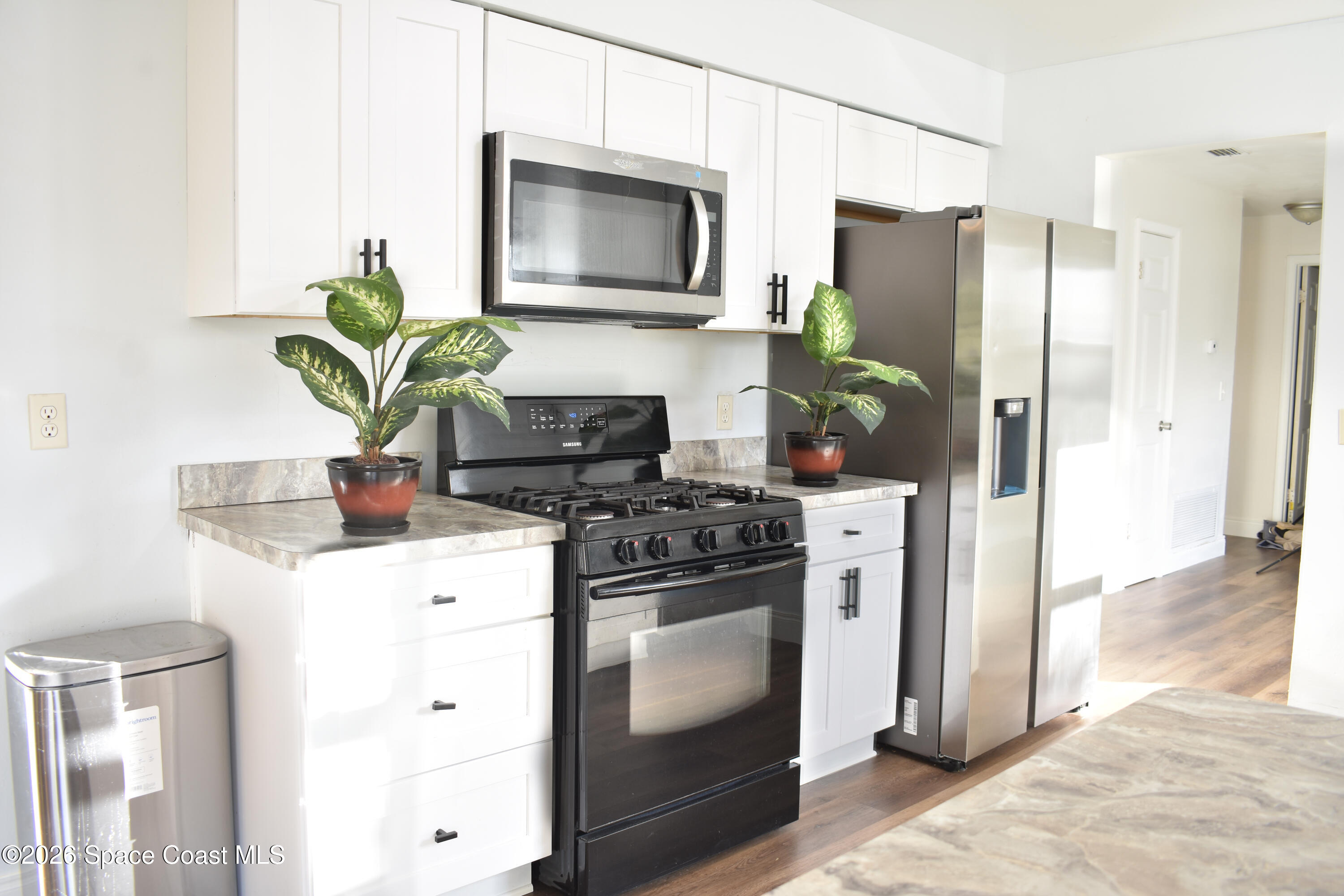 1413 Floyd Drive Rockledge, FL 32955 - Photo 5 of 17 a kitchen with stainless steel appliances a stove a refrigerator a sink a stove and cabinets