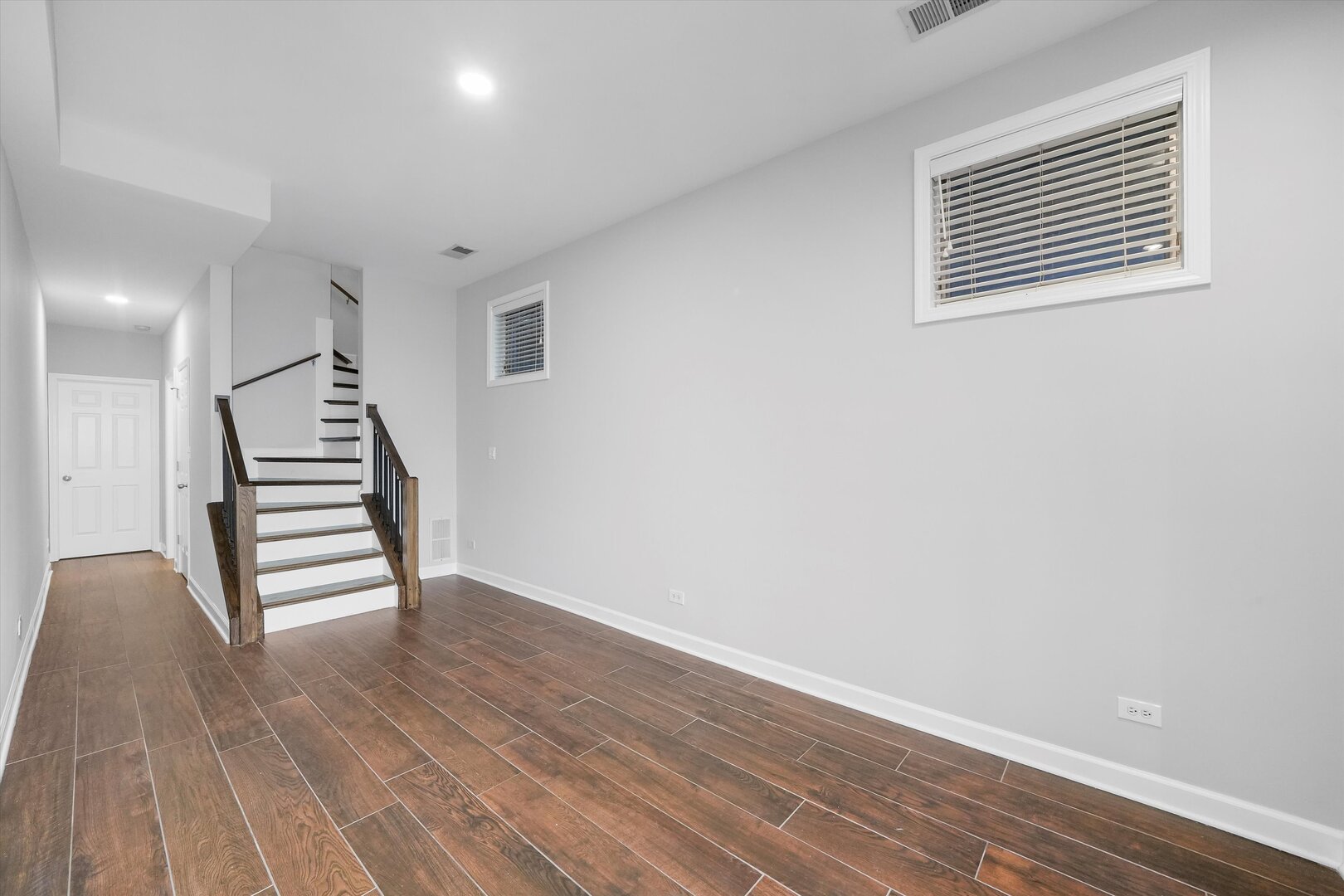2515 West Harrison Street, Unit 1 Chicago, IL 60612 - Photo 22 of 43 wooden floor in an empty room with stairs