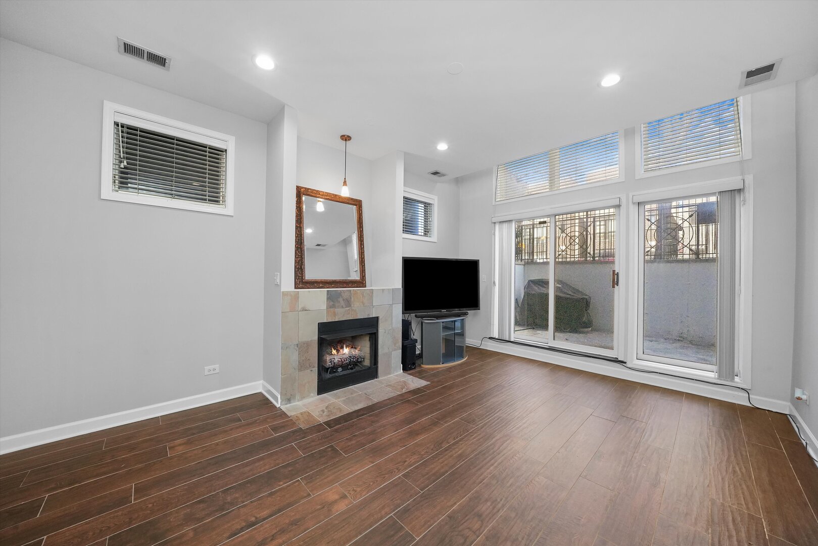 2515 West Harrison Street, Unit 1 Chicago, IL 60612 - Photo 25 of 43 a view of a livingroom with a fireplace wooden floor and window