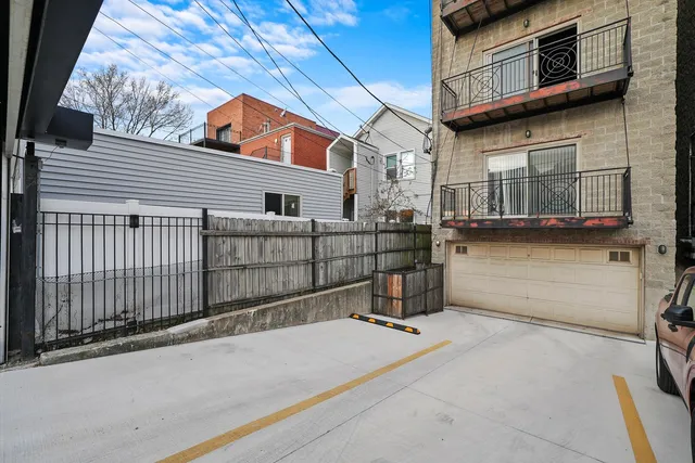a view of a street with wooden fence