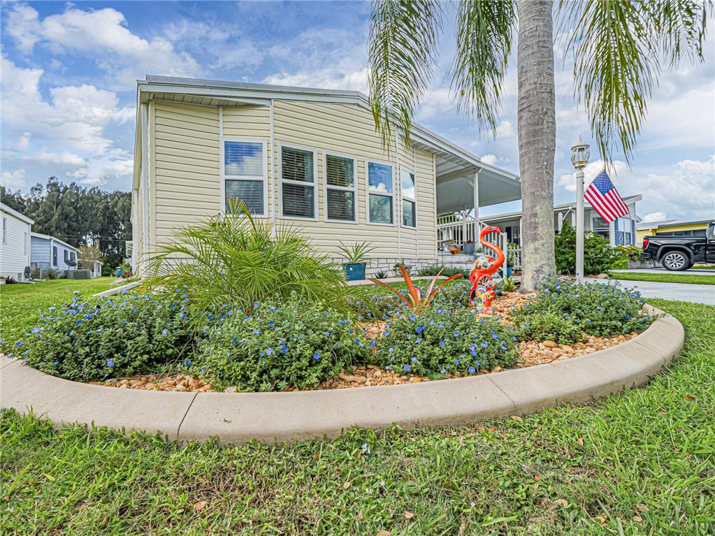 409 Avocado Drive Sebastian, FL 32976 - Photo 2 of 35 a front view of a house with a yard and potted plants