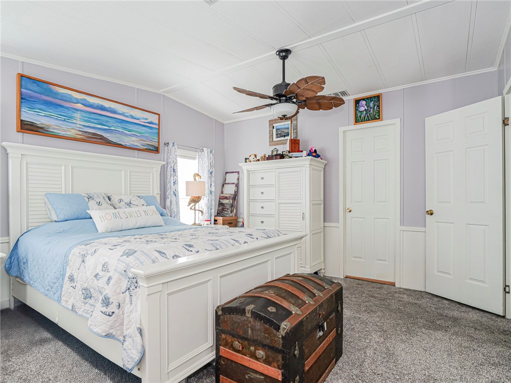 409 Avocado Drive Sebastian, FL 32976 - Photo 21 of 35 a bedroom with a bed and a chandelier