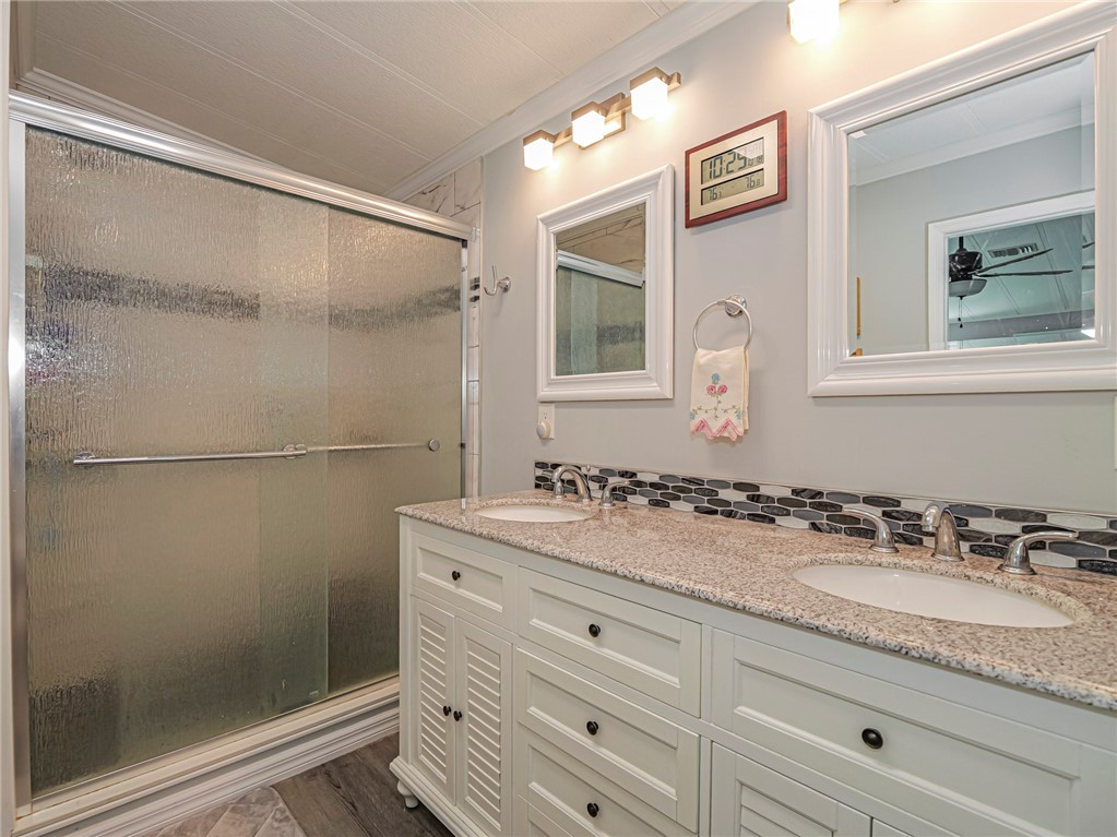 409 Avocado Drive Sebastian, FL 32976 - Photo 26 of 35 a bathroom with a granite countertop sink mirror and double