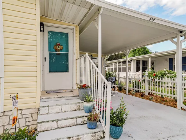 a view of front door and potted plants