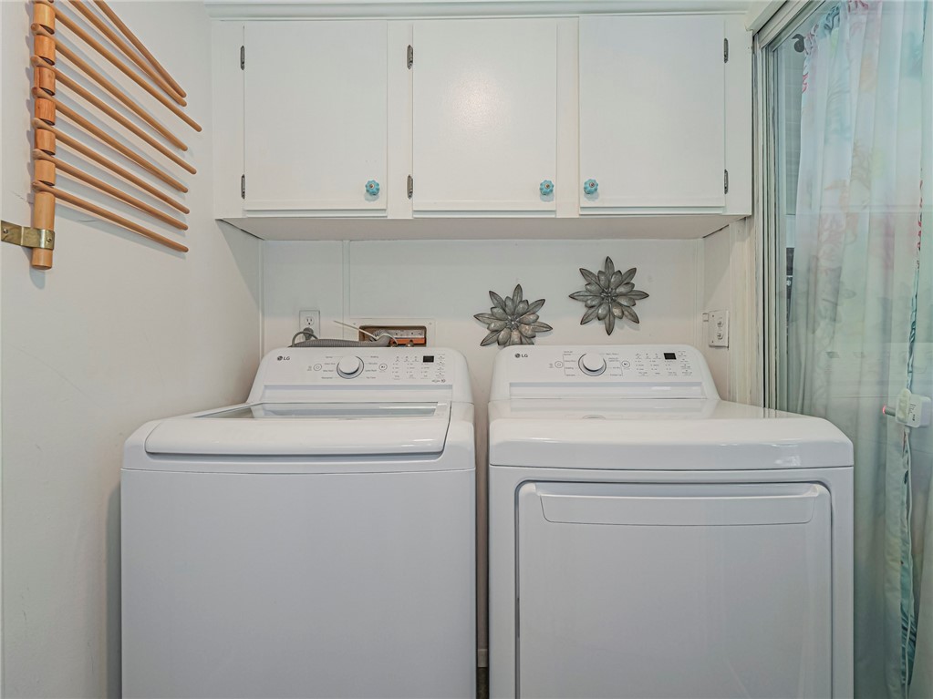 409 Avocado Drive Sebastian, FL 32976 - Photo 32 of 35 a view of washer and dryer with kitchen in the background