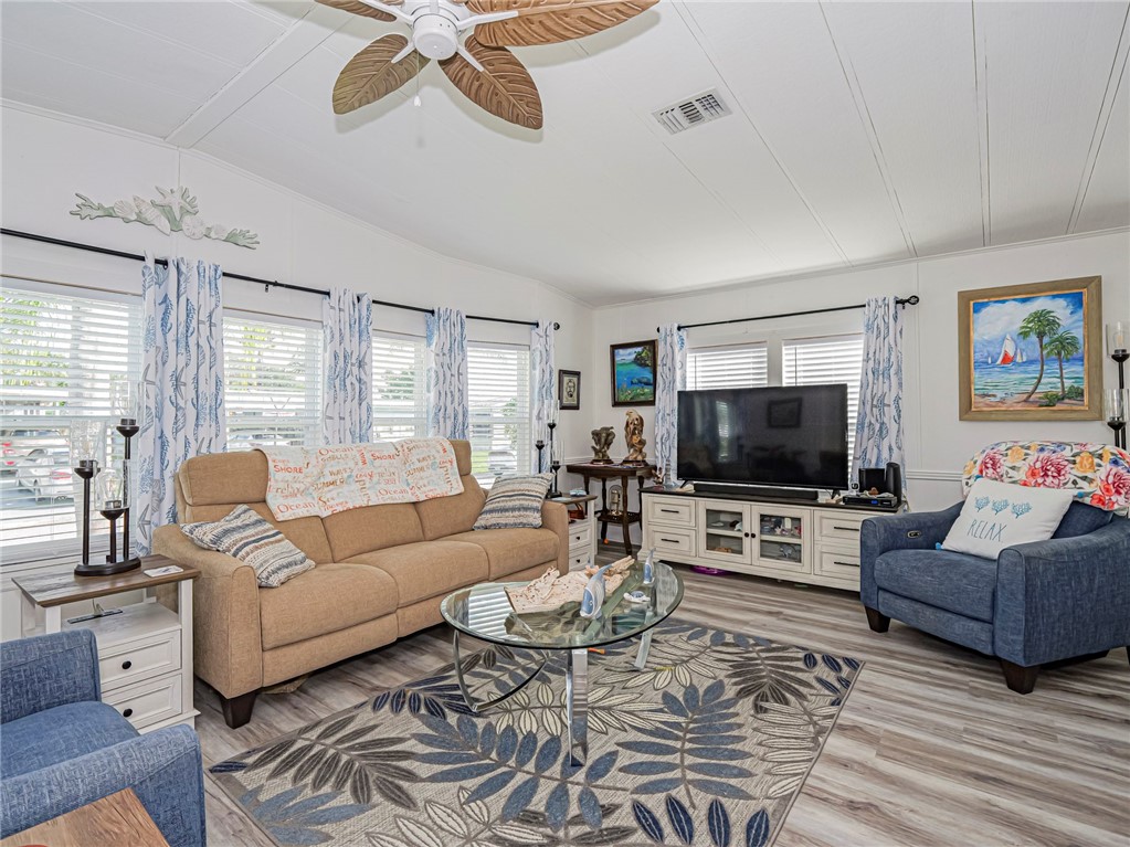409 Avocado Drive Sebastian, FL 32976 - Photo 4 of 35 a living room with furniture and a flat screen tv