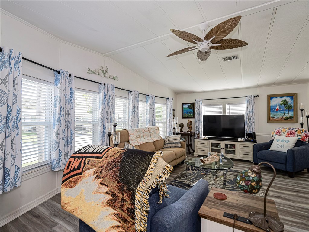 409 Avocado Drive Sebastian, FL 32976 - Photo 5 of 35 a living room with furniture ceiling fan and a window