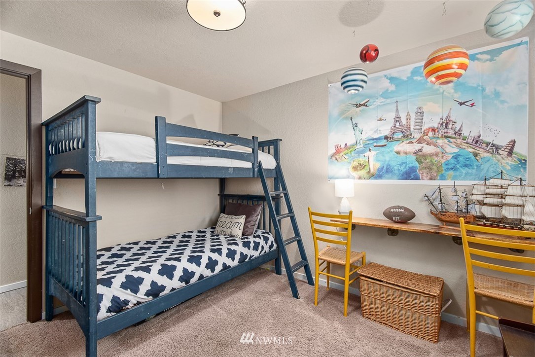 4426 196th Street Southeast Bothell, WA 98012 - Photo 14 of 36 a bedroom with a bed and wooden floor