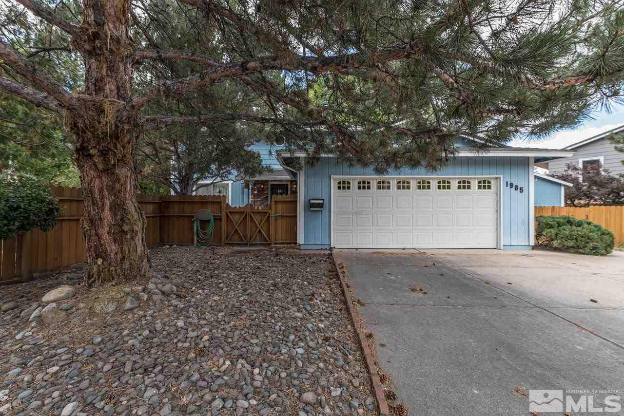 1985 Mayberry Drive Reno, NV 89509 - Photo 1 of 21 a front view of a house with a yard and a garage