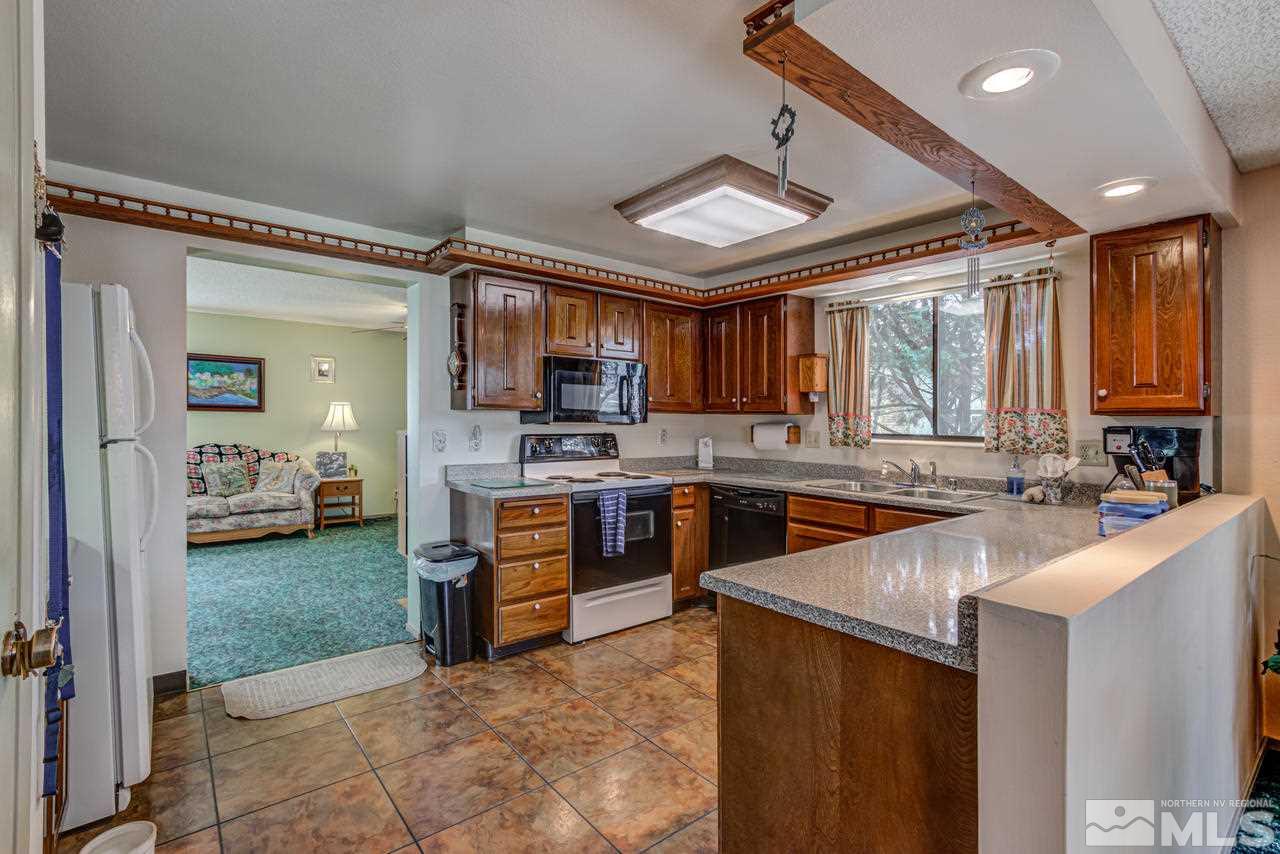 1985 Mayberry Drive Reno, NV 89509 - Photo 5 of 21 a large kitchen with stainless steel appliances granite countertop a stove refrigerator and a sink