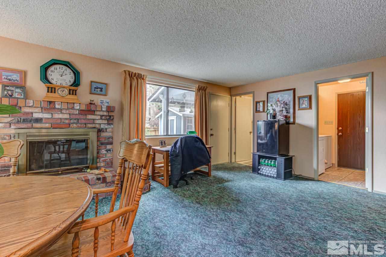1985 Mayberry Drive Reno, NV 89509 - Photo 8 of 21 a living room with furniture a flat screen tv and a fireplace