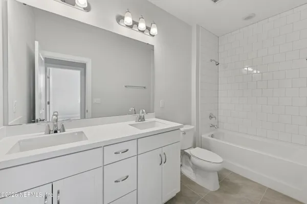 a bathroom with 2 sink and a mirror