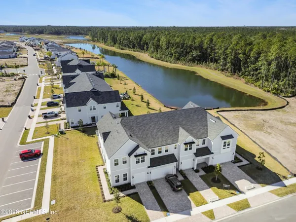 an aerial view of residential houses with outdoor space