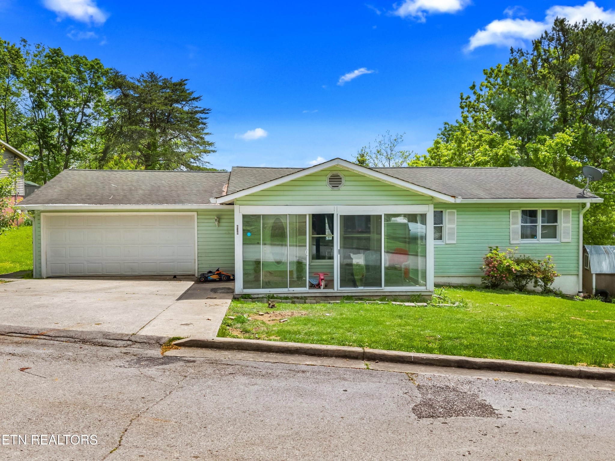 a front view of a house with a yard and garage