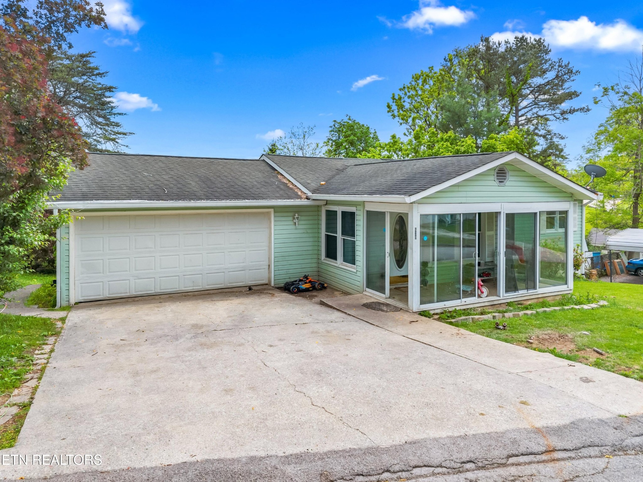 630 South Proctor Boulevard Oneida, TN 37841 - Photo 25 of 32 a front view of a house with a garden and trees