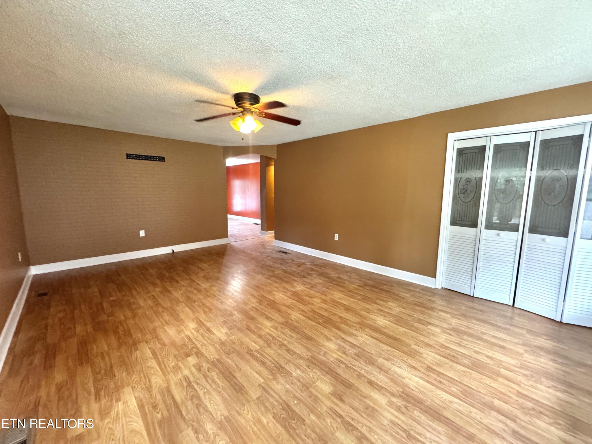 630 South Proctor Boulevard Oneida, TN 37841 - Photo 9 of 32 a view of an empty room with window and wooden floor