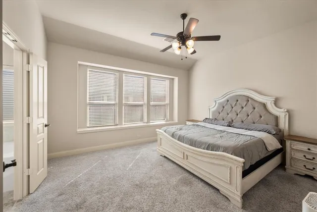 a spacious bedroom with a bed and window