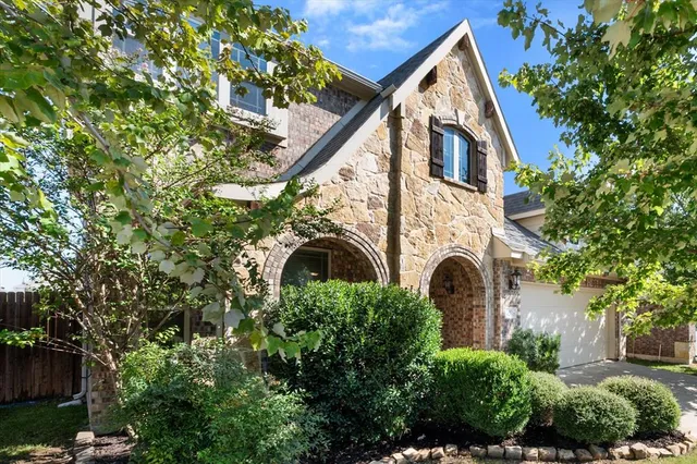 a view of a house with a tree