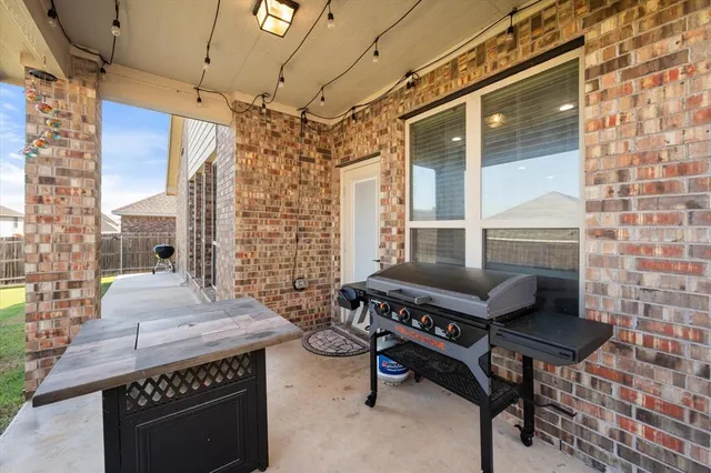 a view of a chairs and table in the balcony
