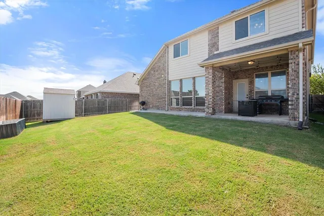 a view of a house with a yard and sitting area