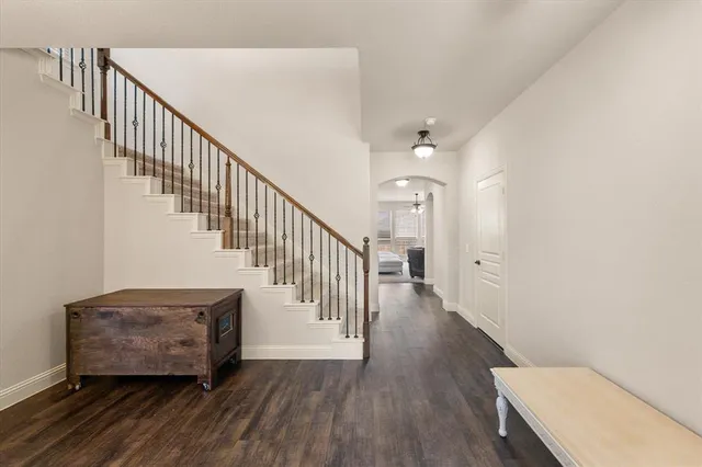a view of entryway and hall with wooden floor