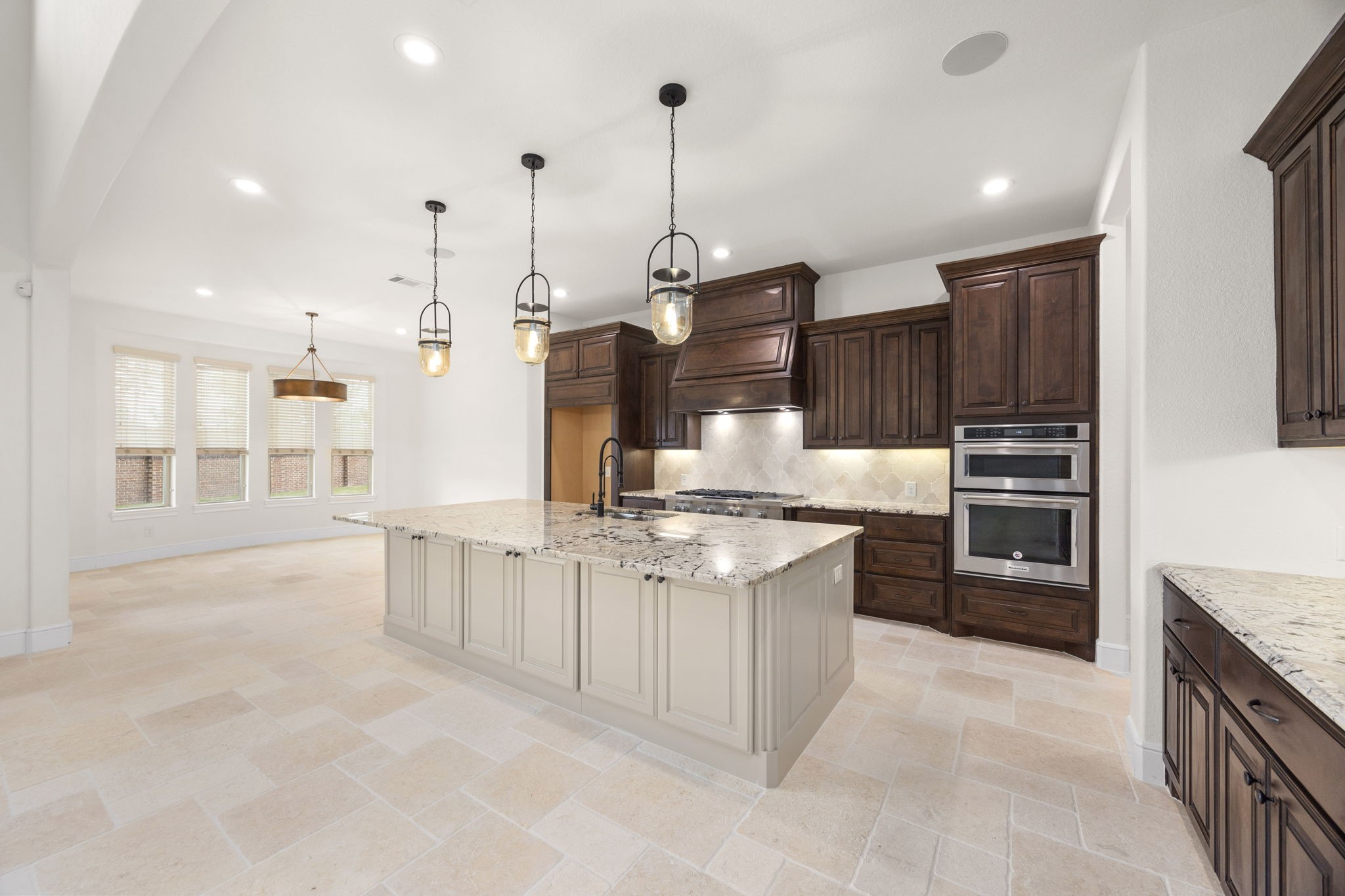 8551 Tombron Grove Road Magnolia, TX 77354 - Photo 4 of 49 Stunning culinary space combines beauty with exceptional functionality. Open-concept layout flows seamlessly into the massive family room for effortless gathering.