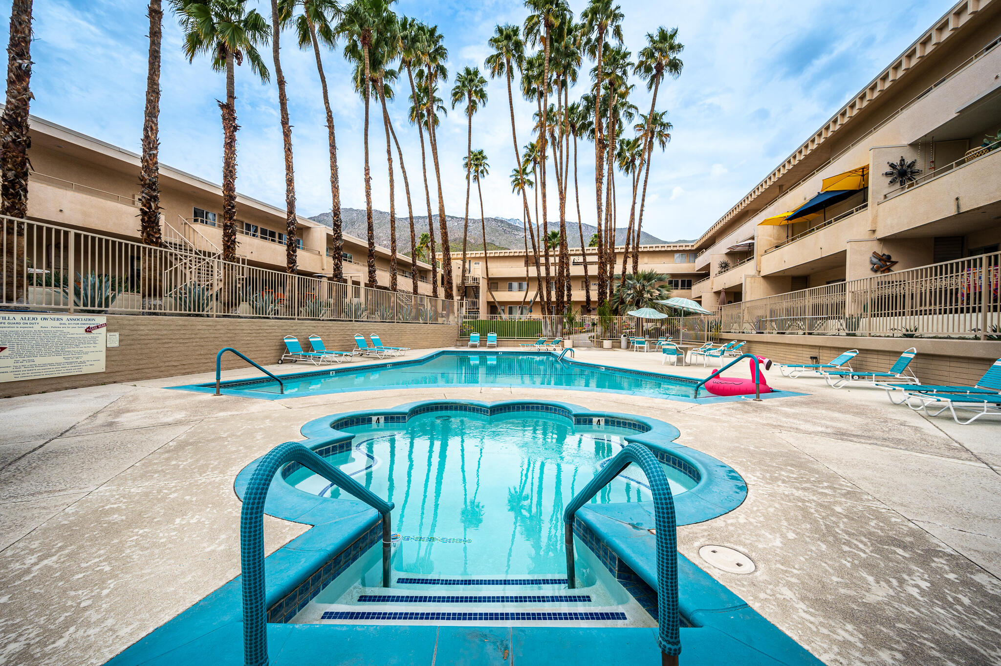 277 East Alejo Road, Unit 113 Palm Springs, CA 92262 - Photo 17 of 27 a view of swimming pool with a yard and palm trees
