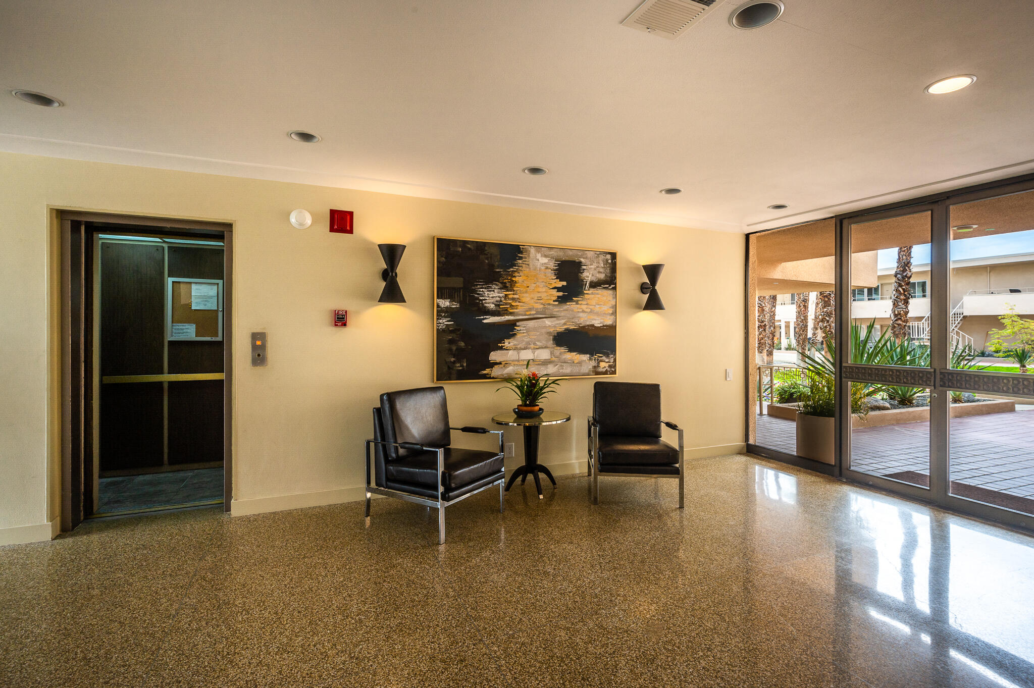 277 East Alejo Road, Unit 113 Palm Springs, CA 92262 - Photo 6 of 27 a living room with furniture and large windows