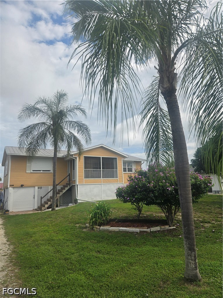 8093 Anhinga Road Fort Myers, FL 33967 - Photo 2 of 49 a view of a house with a yard