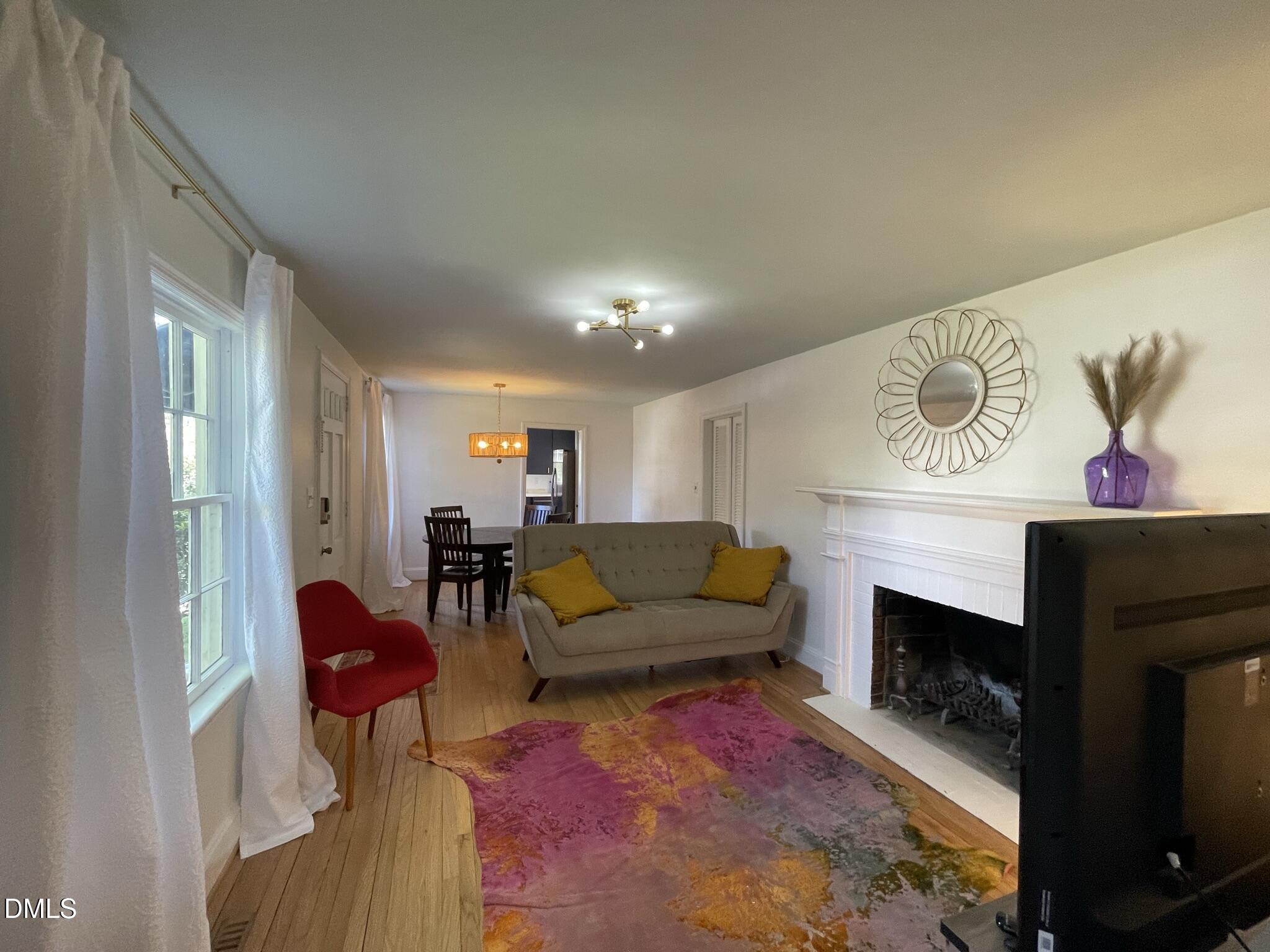 1009 Canterbury Road Raleigh, NC 27607 - Photo 5 of 31 a living room with furniture and a fireplace
